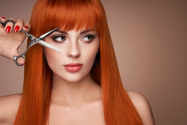 Beautiful young woman with a scissors